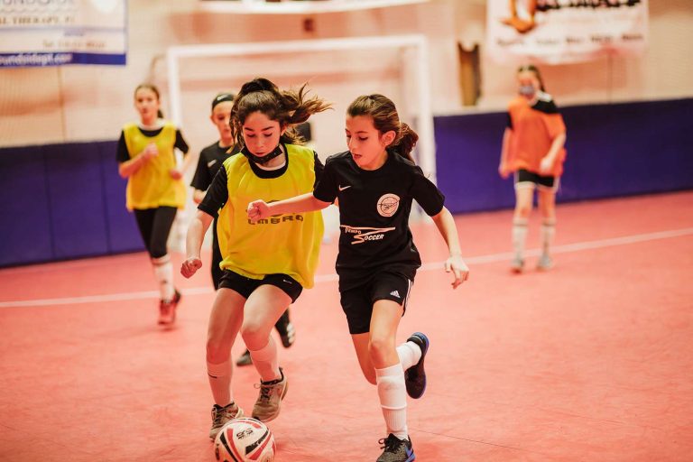 Tiempo players dribbling during an indoor training session