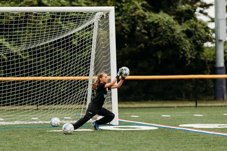 Tiempo goalkeeper diving to make a save in training