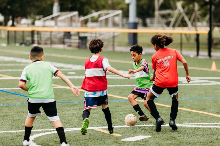 Young players competing for the ball at a Tiempo Soccer session